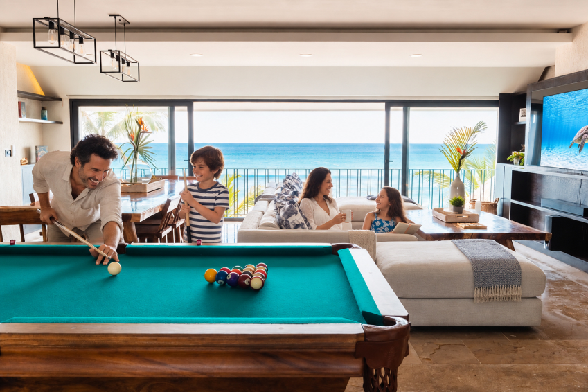 Family bonding over billiards during a relaxed evening at Bella Vita Tulum